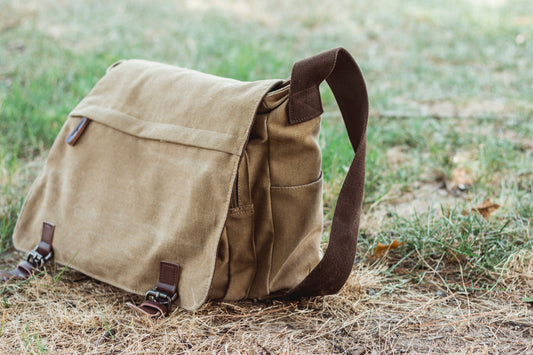 A shoulder bag on a lawn. 